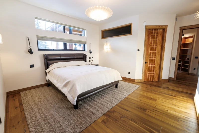 Kasilof Waterfront Remodel — Primary Suite Bedroom Looking into Walk-In Dressing Wing